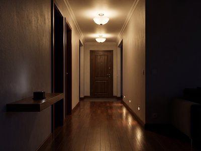 A dark hallway at night with the ceiling lights along the exit route switched on, a small black GeoShake T1 sensor on a shelf